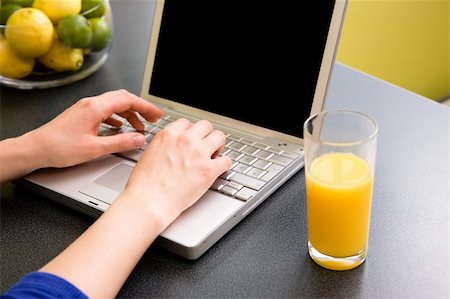 simsearch:400-04443819,k - A computer in the kitchen with a female hand using the touch pad.  The laptop has a completely black screen for easy editing. Stock Photo - Budget Royalty-Free & Subscription, Code: 400-03934685