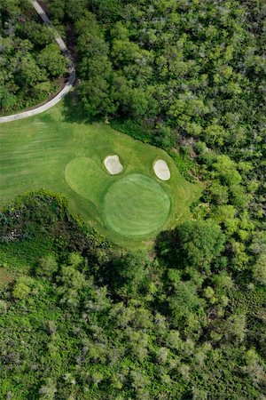 simsearch:400-04468744,k - Aerial view of golf hole on golf course surrounded by trees in Maui, Hawaii. Stock Photo - Budget Royalty-Free & Subscription, Code: 400-03935437