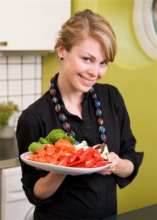 A female in the kitchen looking down on a tasty plate of vegetables Stock Photo - Budget Royalty-Free & Subscription, Code: 400-03935738