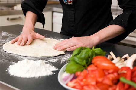 A detail image of a woman making pizza dough on the kitchen counter.  Shallow depth of field is used with the focus on the hands and dough. Stock Photo - Budget Royalty-Free & Subscription, Code: 400-03935742