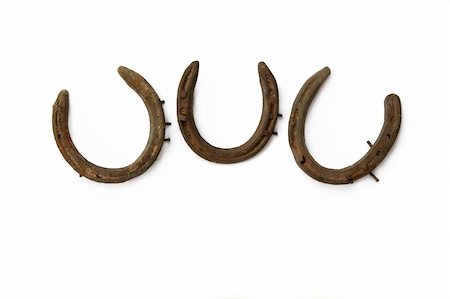 Three old rusty metal horseshoes against a white background. Stock Photo - Budget Royalty-Free & Subscription, Code: 400-03936162