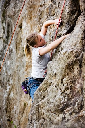 A female rock climber on the face of a steep rock. Stock Photo - Budget Royalty-Free & Subscription, Code: 400-03936233