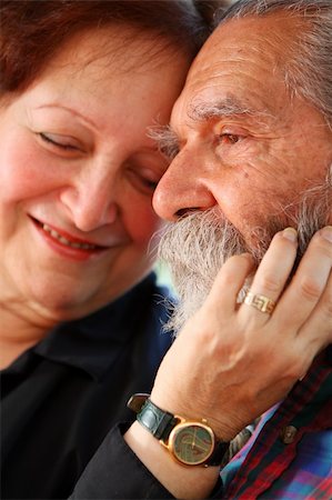 simsearch:400-03969319,k - Affectionate old couple with the wife holding on lovingly to the husband's face. Focus on the husband's eyes. Concept: Elderly love. Stock Photo - Budget Royalty-Free & Subscription, Code: 400-03936952