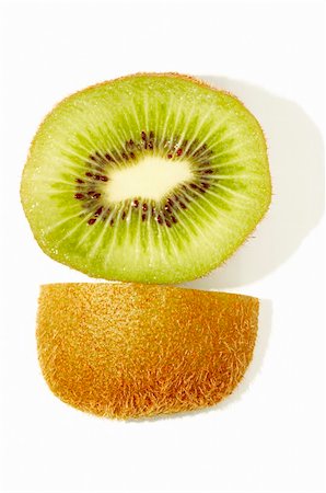 close up of kiwi slice with side view of its skin on white background Stock Photo - Budget Royalty-Free & Subscription, Code: 400-03937105