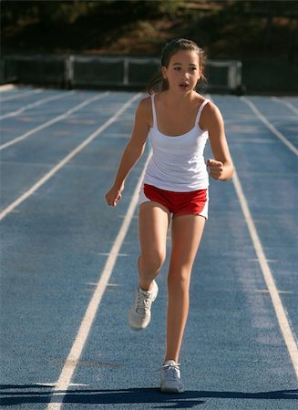 simsearch:614-06311873,k - Girl exercising on a blue racetrack Stockbilder - Microstock & Abonnement, Bildnummer: 400-03937110