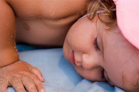 Baby girl taking a nap after playing on the beach Stock Photo - Budget Royalty-Free & Subscription, Code: 400-03937195