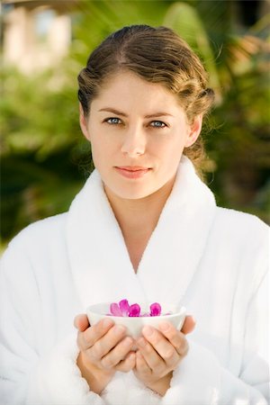 simsearch:400-03940673,k - Attractive Caucasian mid-adult woman in white robe holding bowl of purple orchids floating in water. Stock Photo - Budget Royalty-Free & Subscription, Code: 400-03937620