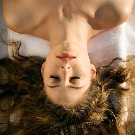 someone laying down aerial view - Above view of bare Caucasian mid-adult  woman lying down with eyes closed and hair spread out. Stock Photo - Budget Royalty-Free & Subscription, Code: 400-03937641