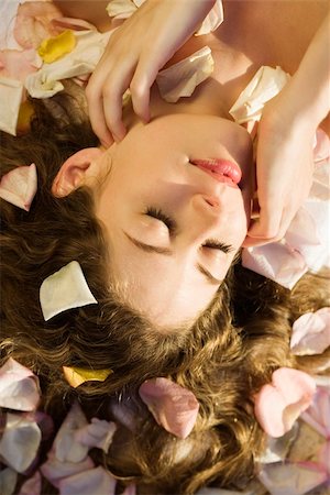 someone laying down aerial view - Above view of Caucasian mid-adult woman lying down with hair spread out on rose petals. Stock Photo - Budget Royalty-Free & Subscription, Code: 400-03937642