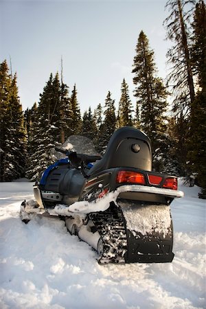 simsearch:400-03944669,k - Snowmobile in snow with trees in background. Photographie de stock - Aubaine LD & Abonnement, Code: 400-03937778