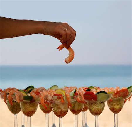 simsearch:400-05204133,k - Woman is having shrimp cocktail on the beach Stock Photo - Budget Royalty-Free & Subscription, Code: 400-03938018