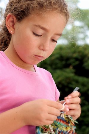 Cute girl knitting. Motion blur on hand. Stock Photo - Budget Royalty-Free & Subscription, Code: 400-03938083