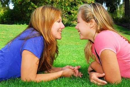 Portrait of smiling mother and daughter in summer park looking at each other Stock Photo - Budget Royalty-Free & Subscription, Code: 400-03938379