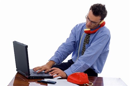 Man running a small business: a laptop, a phone in a small office Stock Photo - Budget Royalty-Free & Subscription, Code: 400-03938398