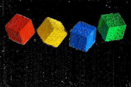 simsearch:640-01349416,k - Four brightly colored cubes floating in a clear bubbly liquid on a black background. Stockbilder - Microstock & Abonnement, Bildnummer: 400-03938688