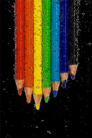simsearch:690-06188906,k - Brightly colored pencils in clear, bubbly liquid. Black background. Photographie de stock - Aubaine LD & Abonnement, Code: 400-03938683