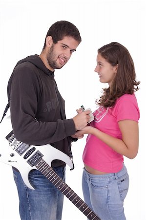 simsearch:400-03910203,k - Young electric guitar player giving an autograph to a beautiful young girl Foto de stock - Super Valor sin royalties y Suscripción, Código: 400-03938824