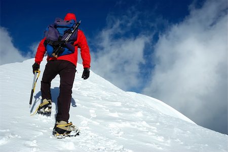 A lonely climber reaching the summit of the mountain Stock Photo - Budget Royalty-Free & Subscription, Code: 400-03939036