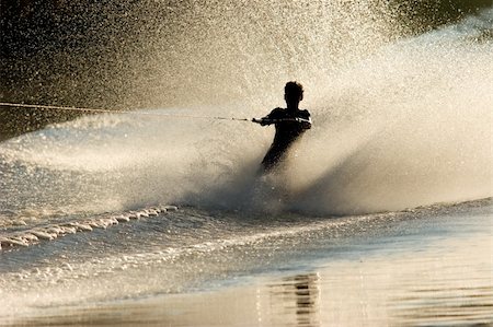 Silhouette of a barefoot skier with backlit water spray Stock Photo - Budget Royalty-Free & Subscription, Code: 400-03939090