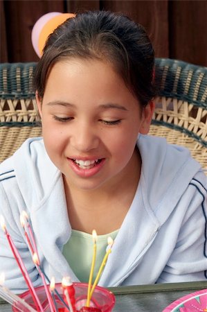 everyday family - Birthday girl making a wish Stock Photo - Budget Royalty-Free & Subscription, Code: 400-03939329