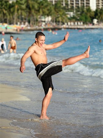 Happy teen boy having fun on the beach Stock Photo - Budget Royalty-Free & Subscription, Code: 400-03939390