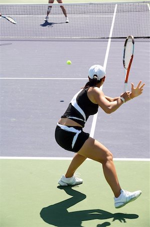 doubles tennis players - Woman playing tennis at the professional tournament Stock Photo - Budget Royalty-Free & Subscription, Code: 400-03939392