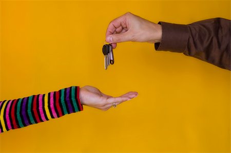 a business man passing the keys to a young woman Stock Photo - Budget Royalty-Free & Subscription, Code: 400-03939561