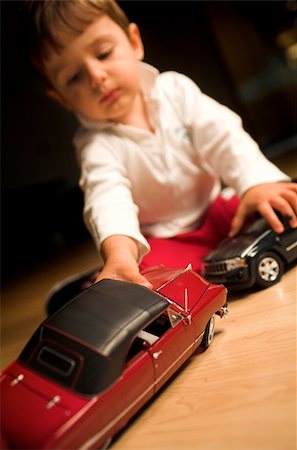 little boy playing indoor with model cars Stock Photo - Budget Royalty-Free & Subscription, Code: 400-03939593