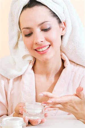 young woman applying cream to her face Stock Photo - Budget Royalty-Free & Subscription, Code: 400-03939848