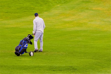 simsearch:400-05038623,k - A golfer with bag, walking along the grass Stock Photo - Budget Royalty-Free & Subscription, Code: 400-03939874