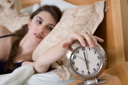 Woman in early waking up to an alarm clock Stock Photo - Budget Royalty-Free & Subscription, Code: 400-03930047