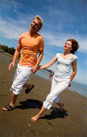 young couple on the beach holding hands Stock Photo - Budget Royalty-Free & Subscription, Code: 400-03930385