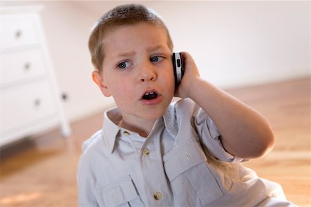 fabthi (artist) - Child talking with a mobile phone looking angry Stock Photo - Budget Royalty-Free & Subscription, Code: 400-03930464