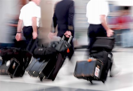 simsearch:400-03948660,k - Pilots in motion rushing through an airport Stock Photo - Budget Royalty-Free & Subscription, Code: 400-03930566