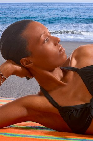 simsearch:614-06169415,k - African-American female relaxing and taking sunbath by sea Photographie de stock - Aubaine LD & Abonnement, Code: 400-03930861
