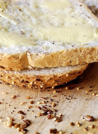 spreading butter on bread - slices of fresh seeded bread, spread with butter Stock Photo - Budget Royalty-Free & Subscription, Code: 400-03931201