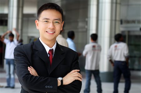 simsearch:6109-06002735,k - Good looking asian business man standing with arms folded. Stock Photo - Budget Royalty-Free & Subscription, Code: 400-03931397