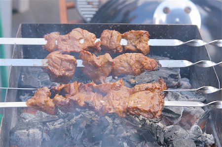 simsearch:400-04573343,k - Appetizing grilled kebab on metal skewers outdoors at picnic Photographie de stock - Aubaine LD & Abonnement, Code: 400-03931418