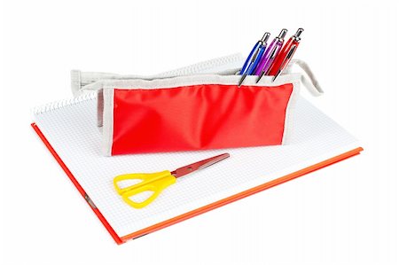 simsearch:690-06188906,k - A red pencil case and yellow scissors over a notebook Photographie de stock - Aubaine LD & Abonnement, Code: 400-03931791