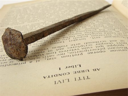 fond de teint - rusty ancient nail on the opened book Photographie de stock - Aubaine LD & Abonnement, Code: 400-03931804