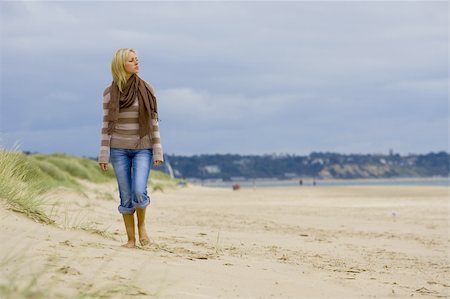 simsearch:6102-08746377,k - A beautiful young blond woman walks along a sandy beach Stock Photo - Budget Royalty-Free & Subscription, Code: 400-03931931