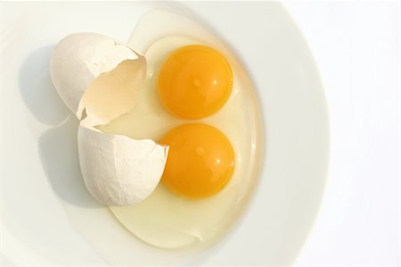 family eating chicken meat - One cracked open raw egg with two yellow yolks, on a  plate against a white background. Stock Photo - Budget Royalty-Free & Subscription, Code: 400-03932122