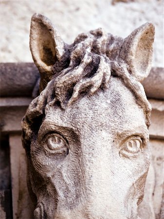 Old horse head sculpture made of stone at entrance of a house. Old Mediterranean house entrance in Dubrovnik. Close up on eyes. Stock Photo - Budget Royalty-Free & Subscription, Code: 400-03932369