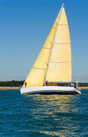 A fully crewed racing yacht sailing on a glorious summer's day Stock Photo - Budget Royalty-Free & Subscription, Code: 400-03932620