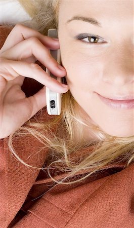 Businesswoman wearing red suit working using  mobile phone. Blong long hair. Photographie de stock - Aubaine LD & Abonnement, Code: 400-03932691