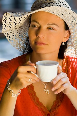 A beautiful young woman drinking coffe in the evening light Stock Photo - Budget Royalty-Free & Subscription, Code: 400-03932844