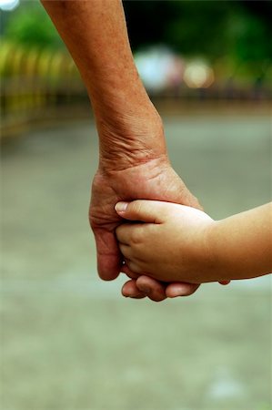 Hand in hand they walk together at park. Stock Photo - Budget Royalty-Free & Subscription, Code: 400-03932856