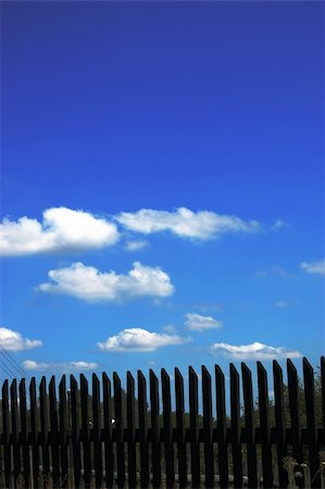 simsearch:400-03932859,k - Fence against blue sky Photographie de stock - Aubaine LD & Abonnement, Code: 400-03932858