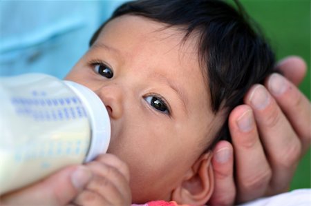 simsearch:400-05130009,k - Very cute baby or toddler in bright pink clothings being fed by her mother. Concept: motherly love Stock Photo - Budget Royalty-Free & Subscription, Code: 400-03933975