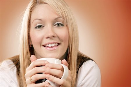 Happy and smiling female drinking coffee in an urban café. Stock Photo - Budget Royalty-Free & Subscription, Code: 400-03944590